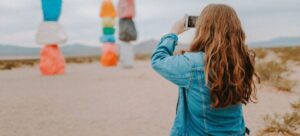 A woman taking photos of sculptures