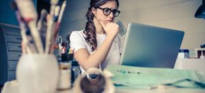 Woman researching on laptop.