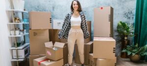 A young woman standing between boxes and thinking about Investing in your LV move